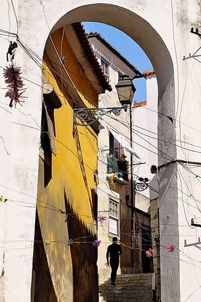 Portugal, Lisbon: staircase in the historical neighborhood of Alfama. Silhouette of a man climbing stairs in a lane of the city, Europe, Western Europe, Portugal