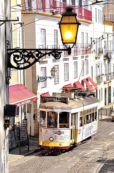 Portugal, Lisbon: tram in Alfama District. Advertising for the alcoholic drink Martini on the tram, Europe, Western Europe, Portugal