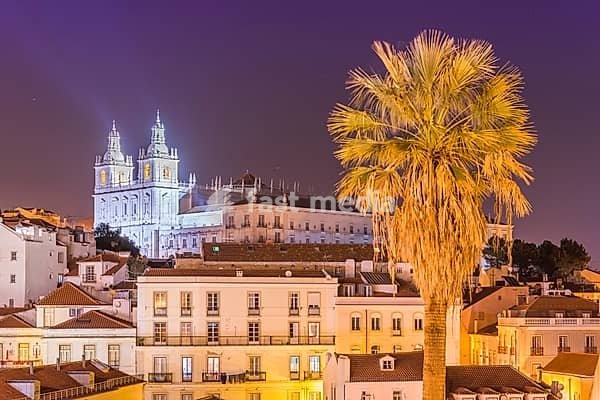 Lisbon cityscape, Alfama district at night. Facade of The Church of São Vicente of Fora (Monastery) illuminated by spotlights. Cultural Heritage of Portugal