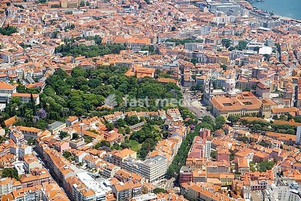 The plane is landing over the Estrela Basilica (Basilica da Estrela) and Estrela Garden (Jardim da Estrela) in the historic part of Lisbon. Portugal