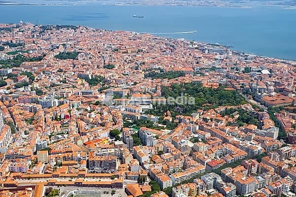 The plane is landing over the Estrela Basilica (Basilica da Estrela) and Estrela Garden (Jardim da Estrela) in the historic part of Lisbon. Portugal