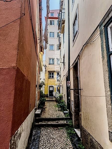 Colourful facades on a narrow alley in the old town of Lisbon, Portugal. Colourful facades in a narrow alley in the old town of Lisbon, Portugal