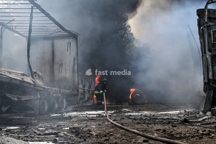 A rescuer pulls a hose during a response effort to a fire at a parking lot, affected by Russian drone strikes, Zaporizhzhia, Ukraine, June 25, 2026. The Russian army attacked the city with strike drones, targeting a petrol station, Ukrzaliznytsia (Ukrainian Railways) locomotives and a parking lot.…