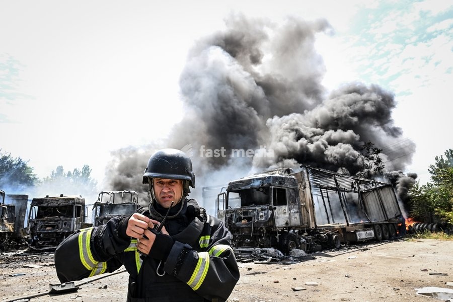 A rescuer stands in front of burning trucks at a parking lot, where a fire broke out due to Russian drone strikes, Zaporizhzhia, Ukraine, June 25, 2026. The Russian army attacked the city with strike drones, targeting a petrol station, Ukrzaliznytsia (Ukrainian Railways) locomotives and a parking…