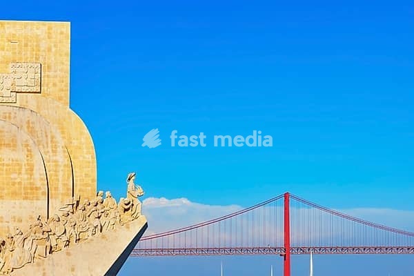 View of Monument to the Discoveries (Padrao dos Descobrimentos) and 25th April bridge in the distance, Belem, Lisbon, Portugal