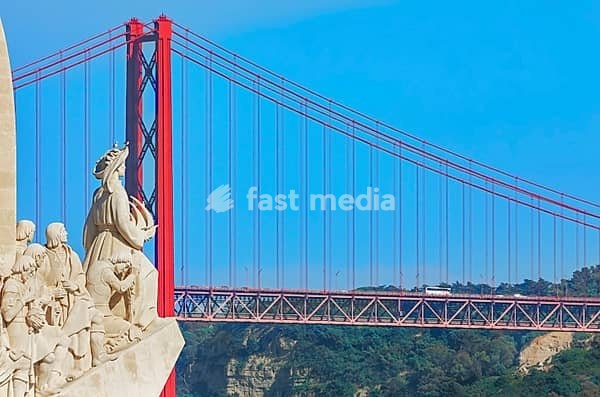 View of Monument to the Discoveries (Padrao dos Descobrimentos) and 25th April bridge in the distance, Belem, Lisbon, Portugal