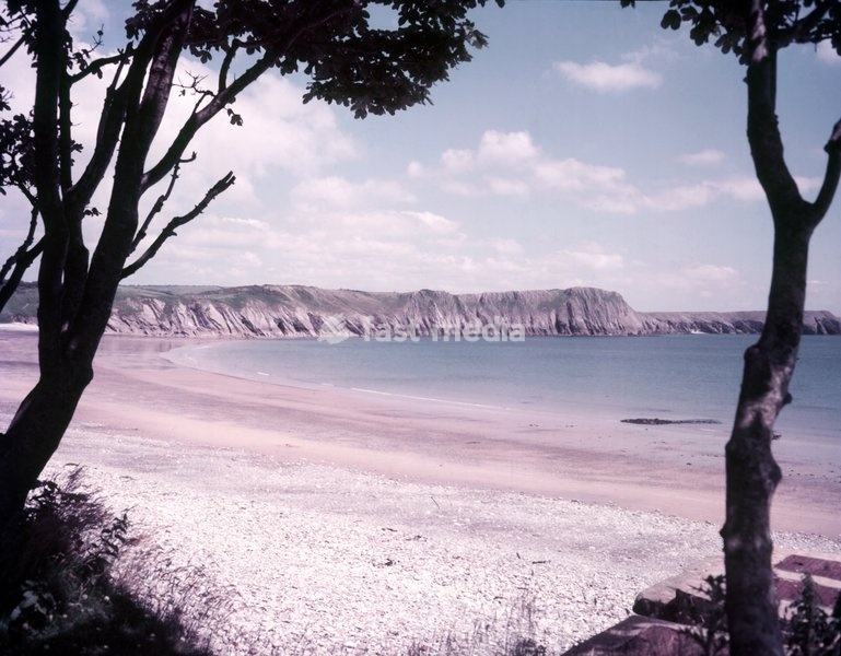 Lydstep Haven, Pembrokeshire, c1955. Lydstep in south Wales was known in ancient times as Lis Castell. A number of ancient artefacts have been recovered from the submerged forest near Lydstep Haven, while peat deposits are periodically exposed showing human and animal footprints radiocarbon dated…