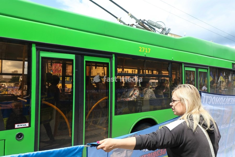 A trolleybus passes a woman holding a banner during the “Don’t Stay Silent! Captivity Kills!” rally in Kharkiv, Ukraine, July 12, 2026. In the northeastern Ukrainian city, families of Ukrainian prisoners of war and missing military personnel took part in the weekly rally to support their relatives…