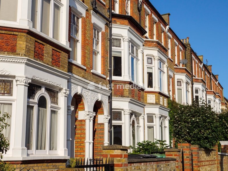 Row of terraced houses on residential street in Hampstead, London, UK