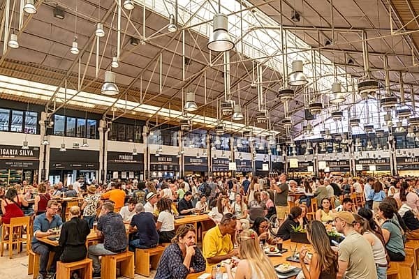 Time Out Market food hall and people dining located in the Mercado da Ribeira at Cais do Sodré, Lisbon, Portugal