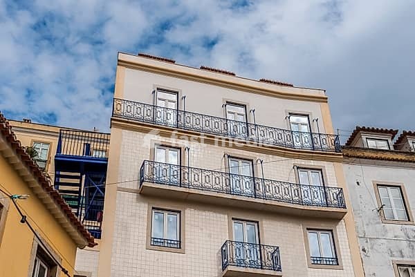 A view of historic buildings in the Alfama quarter of Lisbon, Portugal, showcasing traditional architecture and street details