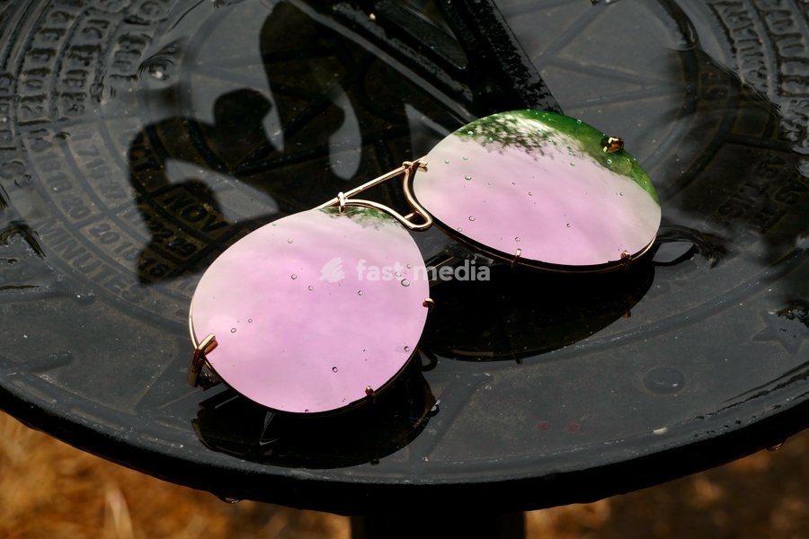 Raindrops on a pair of sunglasses on a sundial