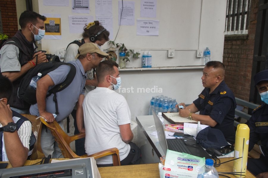 Relatives and media persons gather at the Nepal Police Disaster Management help desk near the morgue at Tribhuvan University Teaching Hospital in Kathmandu, Nepal, Tuesday, Sept. 1, 2026. Officials are processing details of missing persons and unidentified bodies after recent flash floods hit…