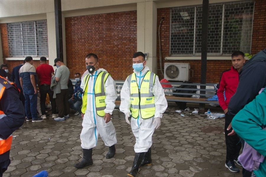 Personnel from the Nepal Police Disaster Management Office (DMO) wearing protective suits stand guard and manage victim identification lists at Tribhuvan University Teaching Hospital in Kathmandu, Nepal, Tuesday, Sept. 1, 2026. Authorities continue to verify identities of those affected by the…