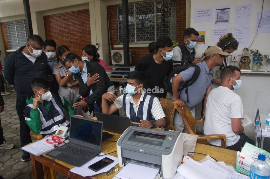 Relatives and media persons gather at the Nepal Police Disaster Management help desk near the morgue at Tribhuvan University Teaching Hospital in Kathmandu, Nepal, Tuesday, Sept. 1, 2026. Officials are processing details of missing persons and unidentified bodies after recent flash floods hit…