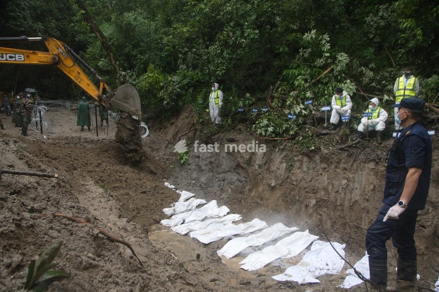 Nepalese Army personnel carry out preparations for the burial of unidentified flash flood victims at a site in Kathmandu, Nepal, Tuesday, Sept. 1, 2026. Security forces have been deployed to manage final rites as recovery efforts continue across flood-affected regions