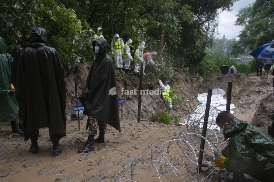 Soldiers of the Nepalese Army coordinate logistics and ground work at a temporary burial ground in Kathmandu, Nepal, Tuesday, Sept. 1, 2026, following catastrophic flooding that claimed hundreds of lives along the Himalayan border area