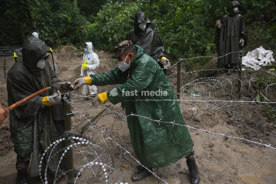 Soldiers of the Nepalese Army coordinate logistics and ground work at a temporary burial ground in Kathmandu, Nepal, Tuesday, Sept. 1, 2026, following catastrophic flooding that claimed hundreds of lives along the Himalayan border area