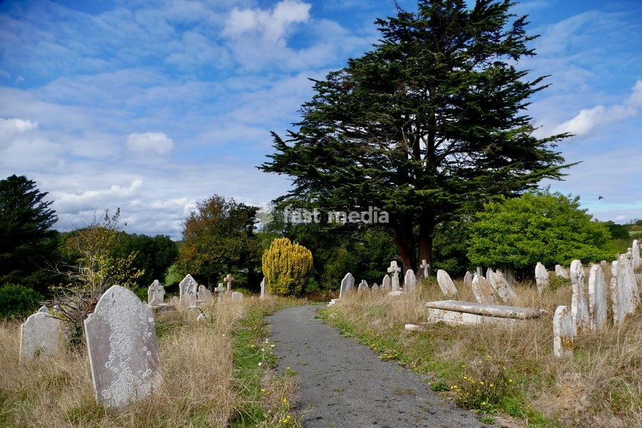 Blue skies and white clouds over the ancient churchyard
