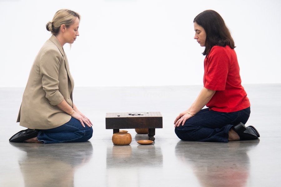 Staff members view 'Visible Labor' (2015) by Gabriel Orozco featuring acrylic on wood, Buddha figures, miniature car models, a GO board game and stones at a photocall for artist Gabriel Orozco's solo exhibition 'Chronotopic' at White Cube Bermondsey, London, England, UK on Monday 14 September, 2026