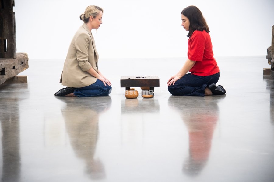 Staff members view 'Visible Labor' (2015) by Gabriel Orozco featuring acrylic on wood, Buddha figures, miniature car models, a GO board game and stones at a photocall for artist Gabriel Orozco's solo exhibition 'Chronotopic' at White Cube Bermondsey, London, England, UK on Monday 14 September, 2026