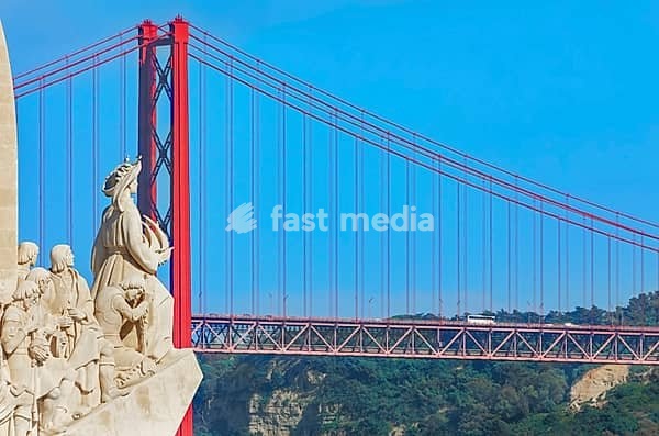 View of Monument to the Discoveries (Padrao dos Descobrimentos) and 25th April bridge in the distance, Belem, Lisbon, Portugal