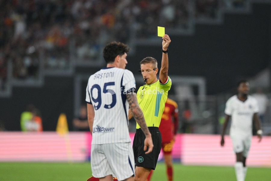 Davide Massa is shown a yellow card to Alessandro Bastoni of Inter during the match of Serie A Enilive Football Match between Roma vs Inter at the Olimpico Stadium on 19 September 2026 in Rome, Lazio, Italy. Roma vs Inter 2-2