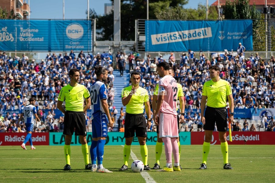 CE Sabadell and Real Oviedo team captains perform the coin toss alongside match officials prior to the LaLiga Hypermotion match day 6 game at Estadi Municipal Nova Creu Alta on September 20, 2026 in Sabadell, Spain