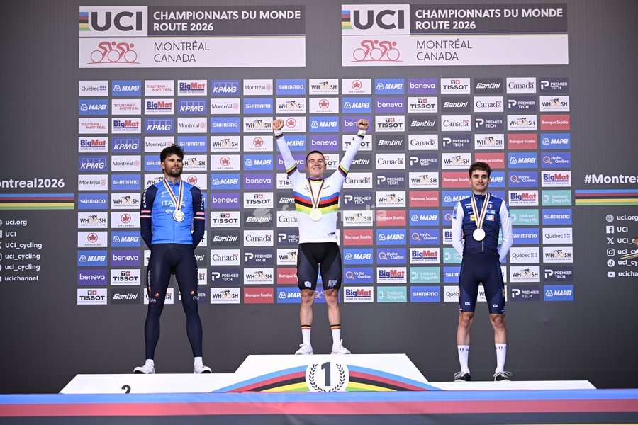 L-R, silver medalist, Italy's Filippo Ganna; winner world champion Belgium's Remco Evenepoel and bronze medalist France's Paul Seixas celebrate on the podium of the men's elite individual time trial race (39,2km) at the cycling UCI Road World Championship, in Montreal, Canada, Sunday 20 September…