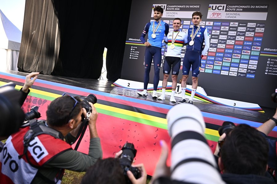 L-R, silver medalist, Italy's Filippo Ganna; winner world champion Belgium's Remco Evenepoel and bronze medalist France's Paul Seixas celebrate on the podium of the men's elite individual time trial race (39,2km) at the cycling UCI Road World Championship, in Montreal, Canada, Sunday 20 September…