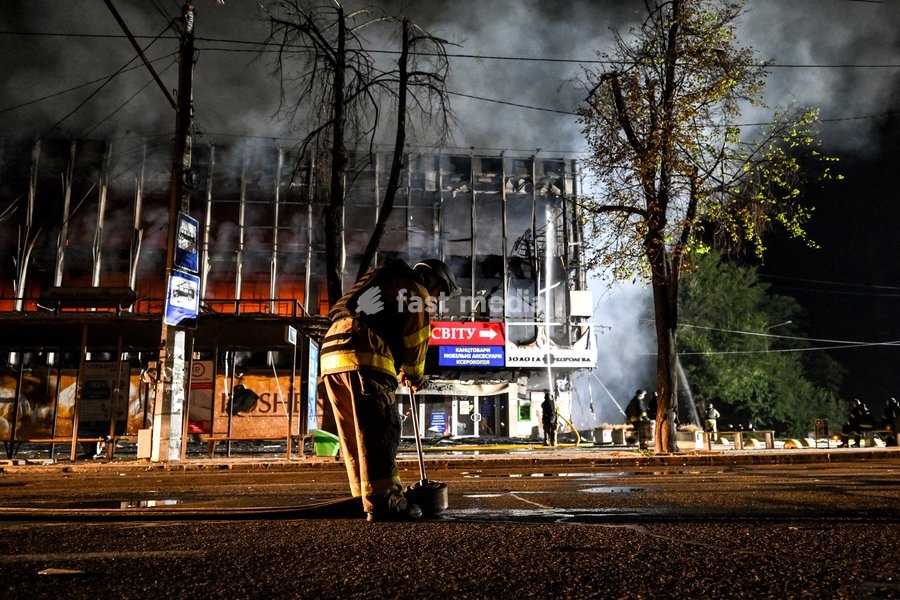 A firefighter rolls out of a fire hose during a response effort to a fire in the Intrade shopping centre caused by an overnight Russian drone attack, Zaporizhzhia, Ukraine, September 21, 2026. On Monday night, Russian forces struck the southeastern city with strike UAVs and an FPV drone. The attack…