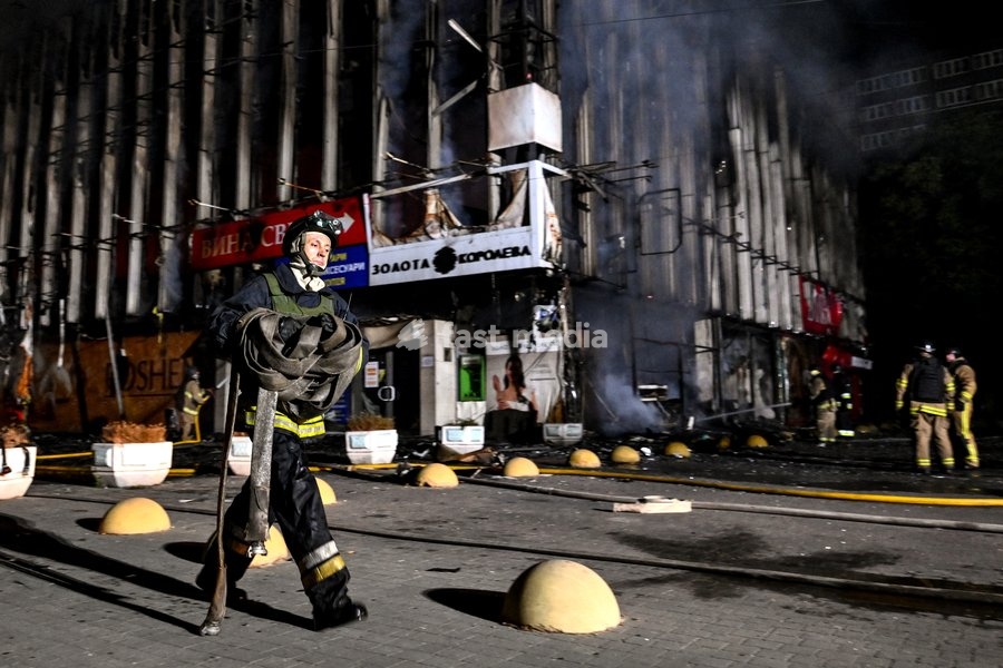 A firefighter carries a roll of fire hose during a response effort to a fire in the Intrade shopping centre caused by an overnight Russian drone attack, Zaporizhzhia, Ukraine, September 21, 2026. On Monday night, Russian forces struck the southeastern city with strike UAVs and an FPV drone. The…