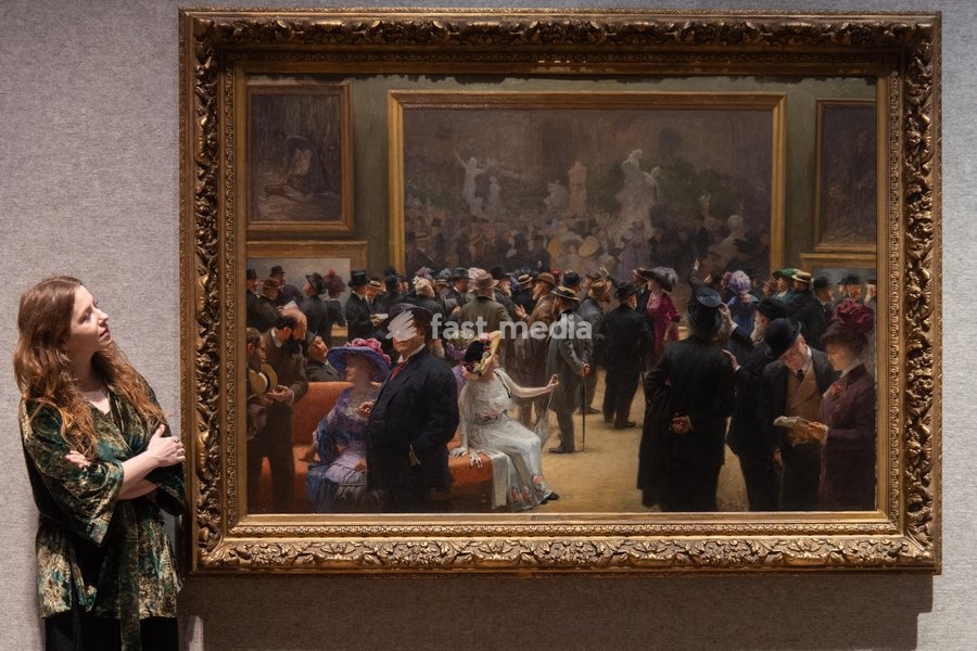 A staff member views 'Au Salon des Artistes Français en 1911' by Henri Adolphe Laissement (est. £100k - £150k) which is to go on auction at Bonhams' 19th Century and British Impressionist Art Sale on 23rd September 2026 at Bonhams in London, England, UK on Monday 21 September, 2026