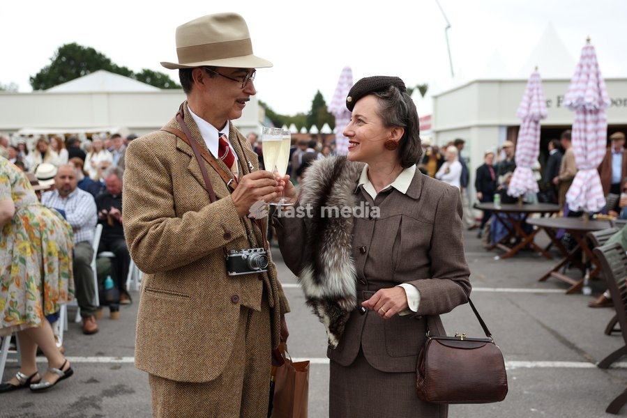 Racegoers in vintage fashion on day two of Goodwood Revival presented by Dunlop at the Goodwood Motor Circuit in Chichester, West Sussex. Picture date: Saturday September 19, 2026. This year's Revival is bringing La Dolce Vita to life with a track parade of over 300 Vespas and vintage scooters, a…