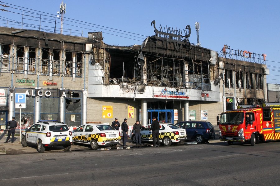Police cars and a fire engine are parked outside the New Continent shopping centre, which shows extensive damage after being set ablaze by a targeted Russian jet-drone strike on Saturday evening, September 19, 2026, Dnipro, Ukraine, September 20, 2026