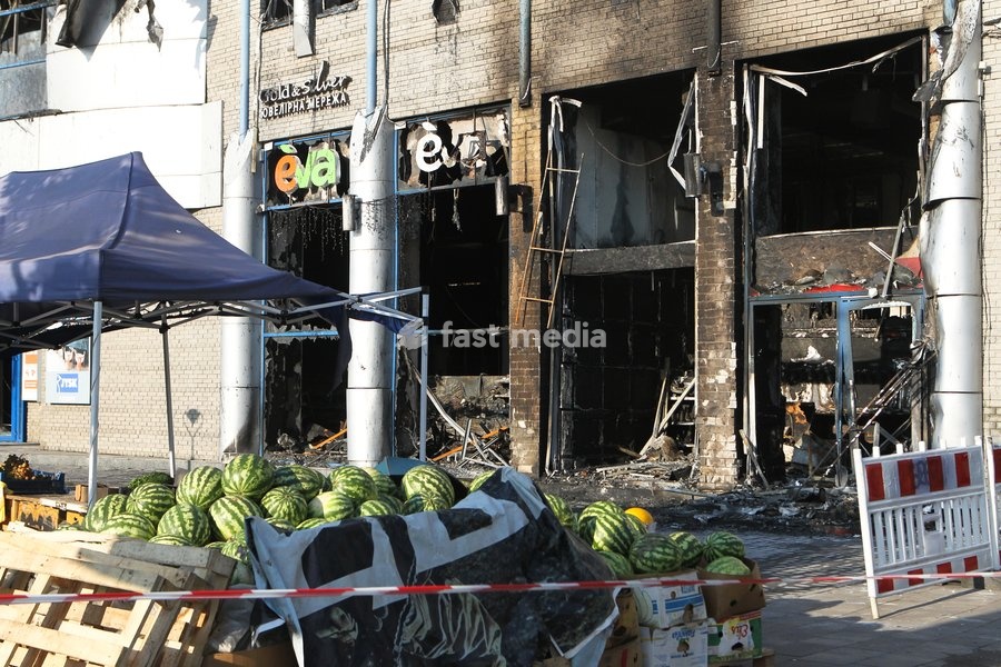 A stall with watermelons is in front of the New Continent shopping centre, which shows extensive damage after being set ablaze by a targeted Russian jet-drone strike on Saturday evening, September 19, 2026, Dnipro, Ukraine, September 20, 2026