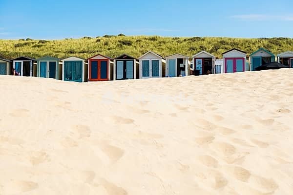 Sandy beach beach with beach huts and blue sky, Wijk aan Zee, North Sea, North Holland, Netherlands