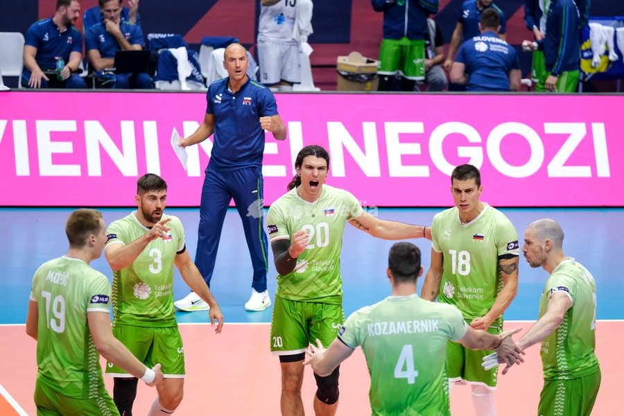 Nik Mujanović of Slovenia (C) exults with his team during the Slovenia vs Serbia match at Final Eight of the CEV Enel EuroVolley 2026 Men at PalaVela in Turin, Italy, on September 21, 2026. Slovenia wins the match against Serbia with a score 3-0