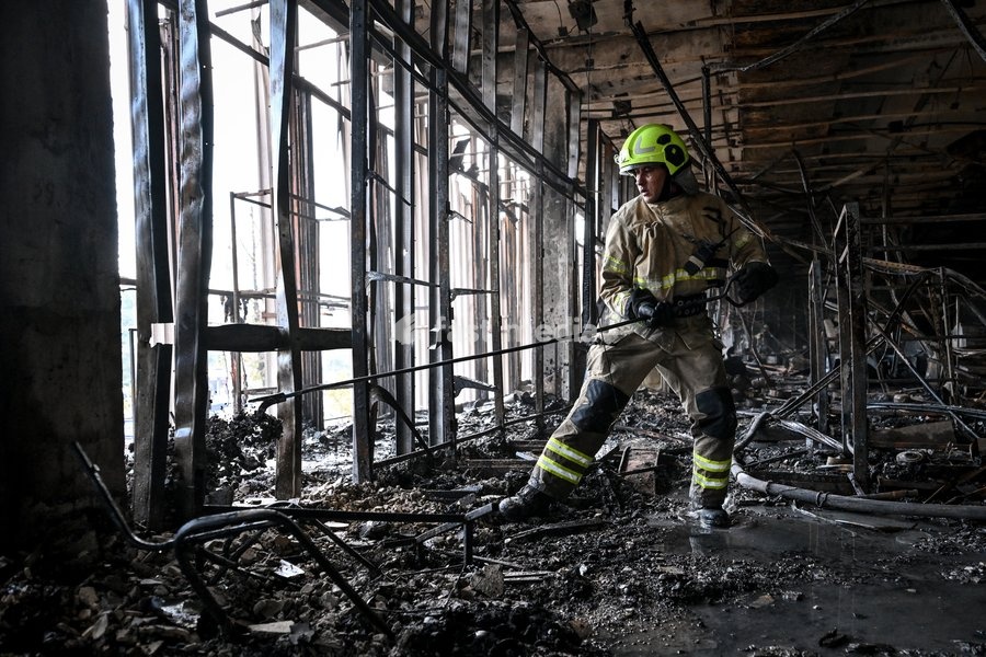 A State Emergency Service rescuer searches for hotspots during a response effort in the Intrade shopping centre, which burned down following a Russian drone attack, Zaporizhzhia, Ukraine, September 21, 2026. Overnight, Russian forces struck the city with strike UAVs and an FPV drone. The attack…