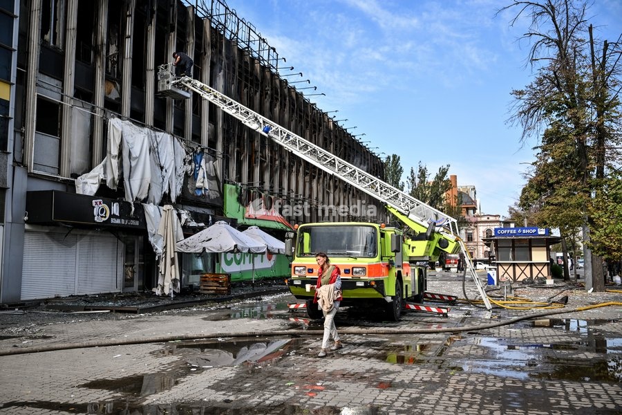 A rescuer climbs a fire ladder to the second-floor window of the Intrade shopping centre, which burned down following a Russian drone attack, during a response effort in Zaporizhzhia, Ukraine, September 21, 2026. Overnight, Russian forces struck the city with strike UAVs and an FPV drone. The…