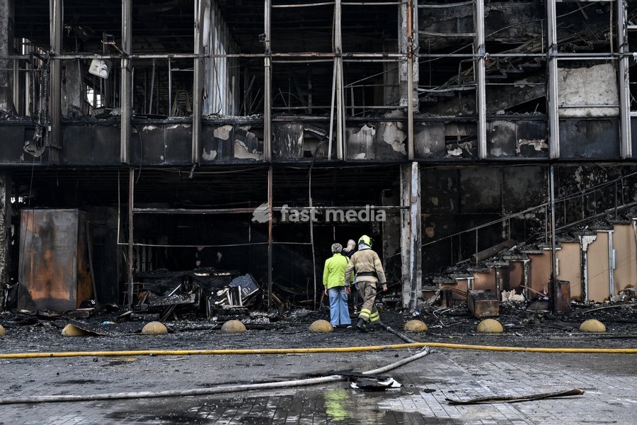 A rescuer accompanies entrepreneurs, who rented spaces, to the fire-stricken Intrade shopping centre, which burned down following a Russian drone attack, Zaporizhzhia, Ukraine, September 21, 2026. Overnight, Russian forces struck the city with strike UAVs and an FPV drone. The attack destroyed a…