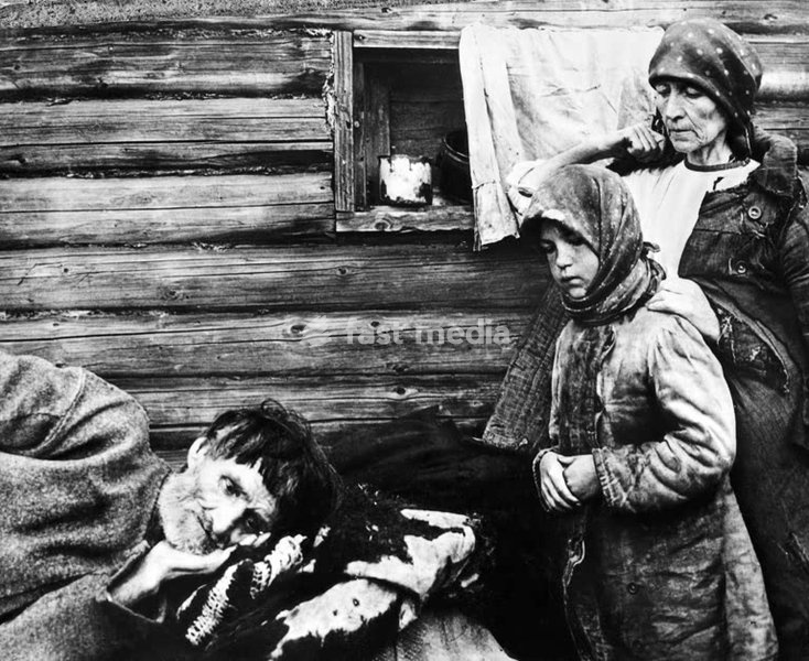 Histoire de l'URSS / Famine de la Volga (1921-1922) Une famille de paysans affamés devant les rondins de bois de leur isba : un homme alité à l'agonie veillé par son épouse et sa fille. (Conséquence directe des destructions de la guerre civile russe, de la politique brutale de réquisitions forcées…