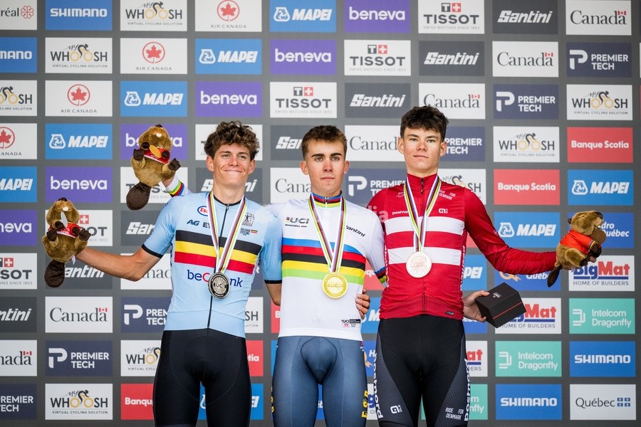 L-R, silver medalist Belgian Vic De Smet, winner with his gold medal Spain's Benjamin Noval and bronze medalist Denmark's Malthe Risbjerg celebrate on the podium of the men's Junior individual time trial race (20,03 km) at the cycling UCI Road World Championship, in Montreal, Canada, Tuesday 22…