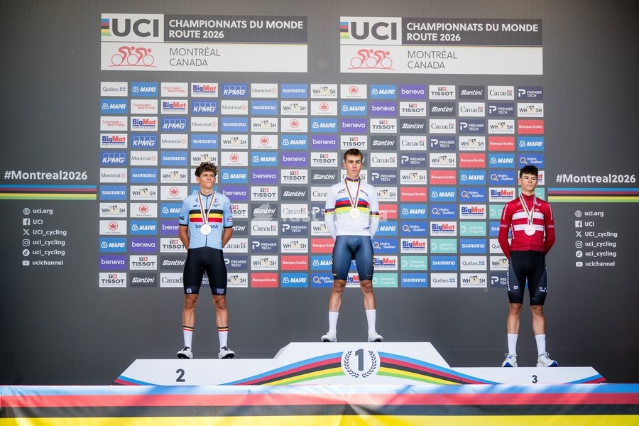 L-R, silver medalist Belgian Vic De Smet, winner with his gold medal Spain's Benjamin Noval and bronze medalist Denmark's Malthe Risbjerg celebrate on the podium of the men's Junior individual time trial race (20,03 km) at the cycling UCI Road World Championship, in Montreal, Canada, Tuesday 22…