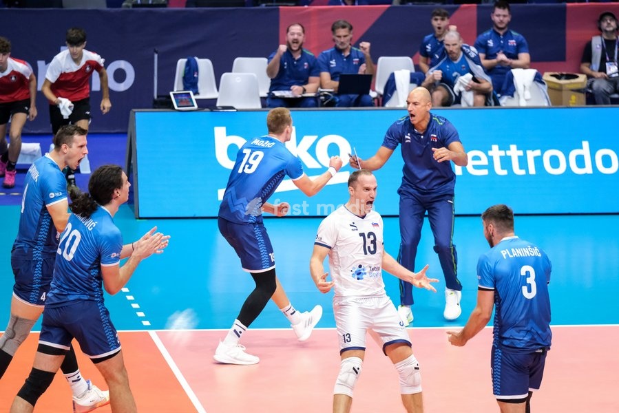 Jani Kovačič of Slovenia (C) exults with his team during the Belgium vs Slovenia match at Quarter Final of the CEV Enel EuroVolley 2026 Men at PalaVela in Turin, Italy, on September 23, 2026. Belgium losts the match against Slovenia with a score 1-3