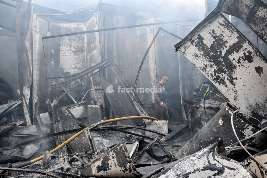An entrepreneur walks through piles of burnt scrap metal among the destroyed rows of stalls at the Central Clothes Market (Anholenko) in Zaporizhzhia, Ukraine, September 26, 2026. The market sustained significant damage in a Russian drone attack