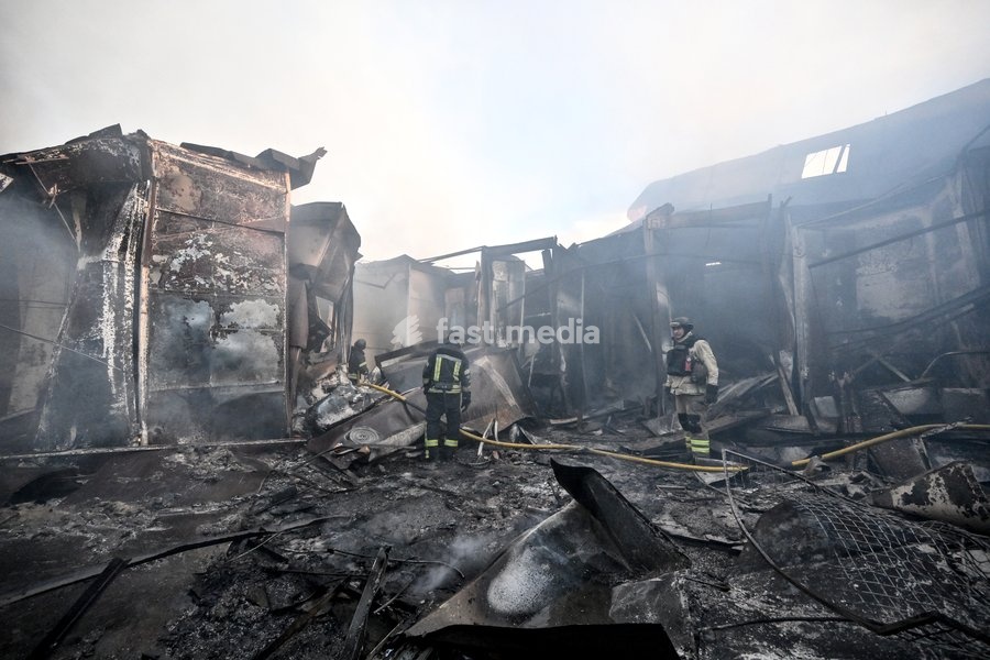 State Emergency Service rescuers work amid burnt-out metal containers at the Central Clothes Market (Anholenko) in Zaporizhzhia, Ukraine, September 26, 2026. The market sustained significant damage in a Russian drone attack