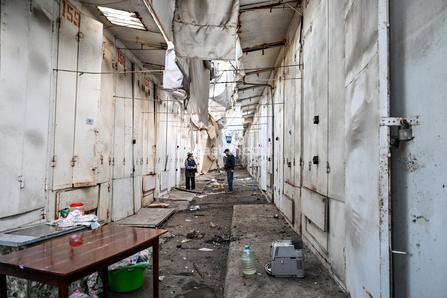 A man and a woman stand in the passage between the stalls at the Central Clothes Market (Anholenko) in Zaporizhzhia, Ukraine, September 26, 2026. The market sustained significant damage in a Russian drone attack