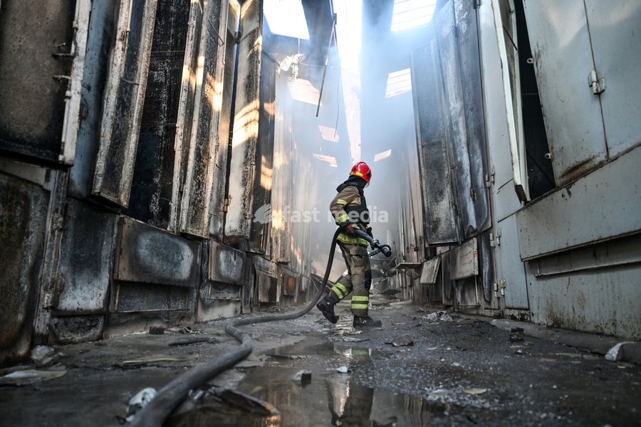 A State Emergency Service rescuer carries a fire hose as he walks along a smoke-filled passageway to extinguish a fire at the Central Clothes Market (Anholenko) in Zaporizhzhia, Ukraine, September 26, 2026. The market sustained significant damage in a Russian drone attack