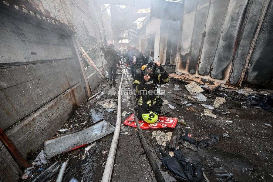 A State Emergency Service rescuer, wearing protective gear, works in a smoke-filled passageway to extinguish a fire at the Central Clothes Market (Anholenko) in Zaporizhzhia, Ukraine, September 26, 2026. The market sustained significant damage in a Russian drone attack